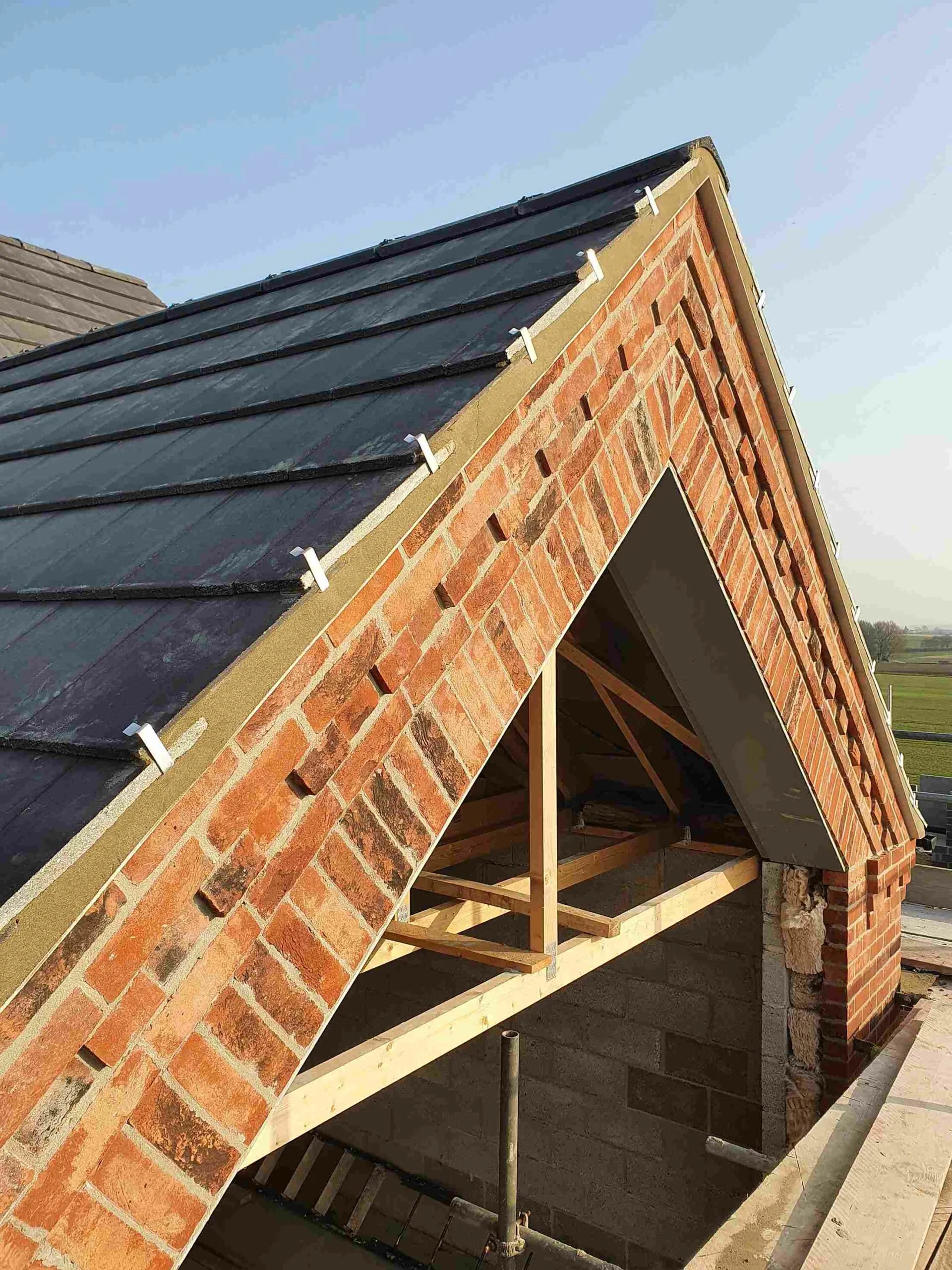 A red brick roof-gable end.