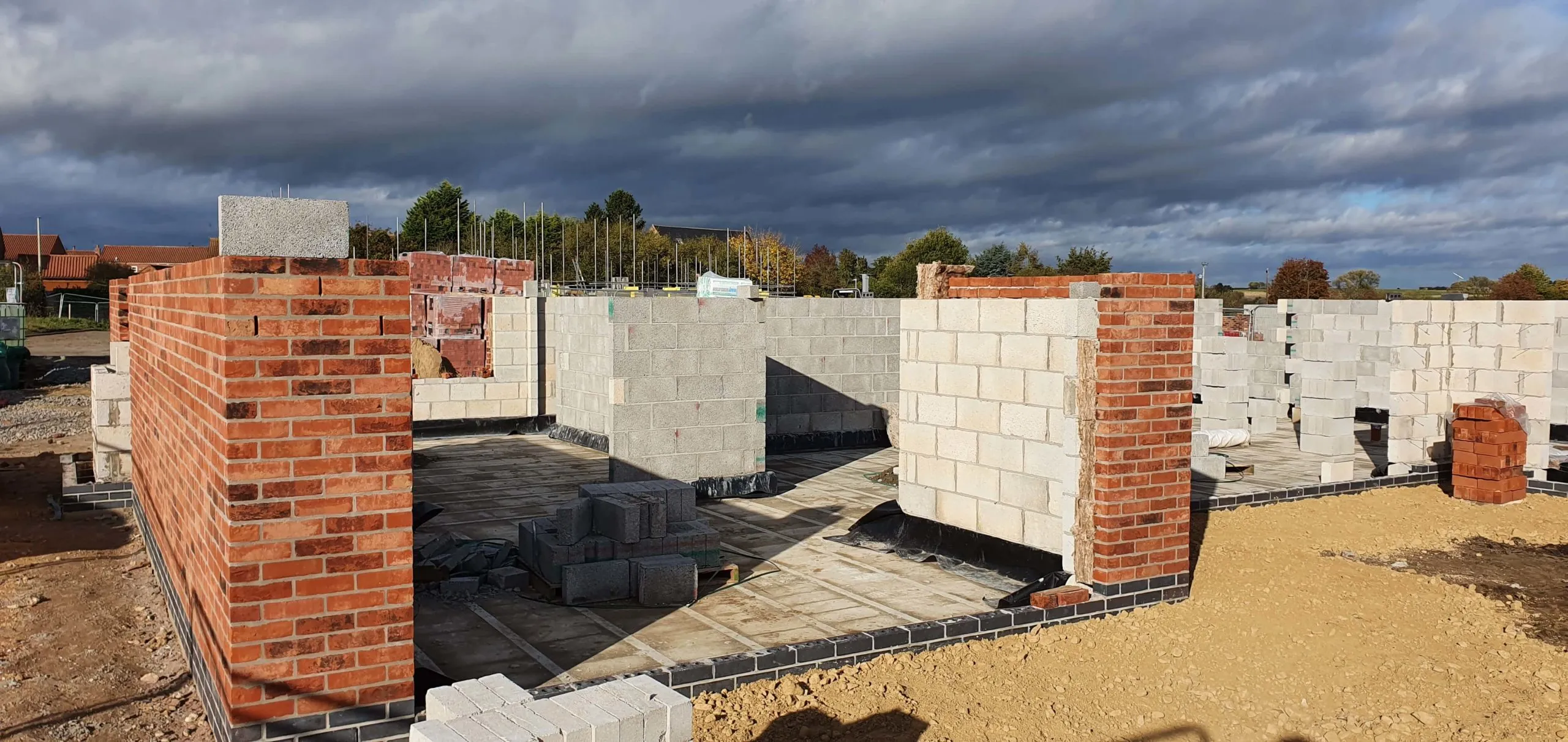 The ground level walls with bricks encasing the breeze-block.