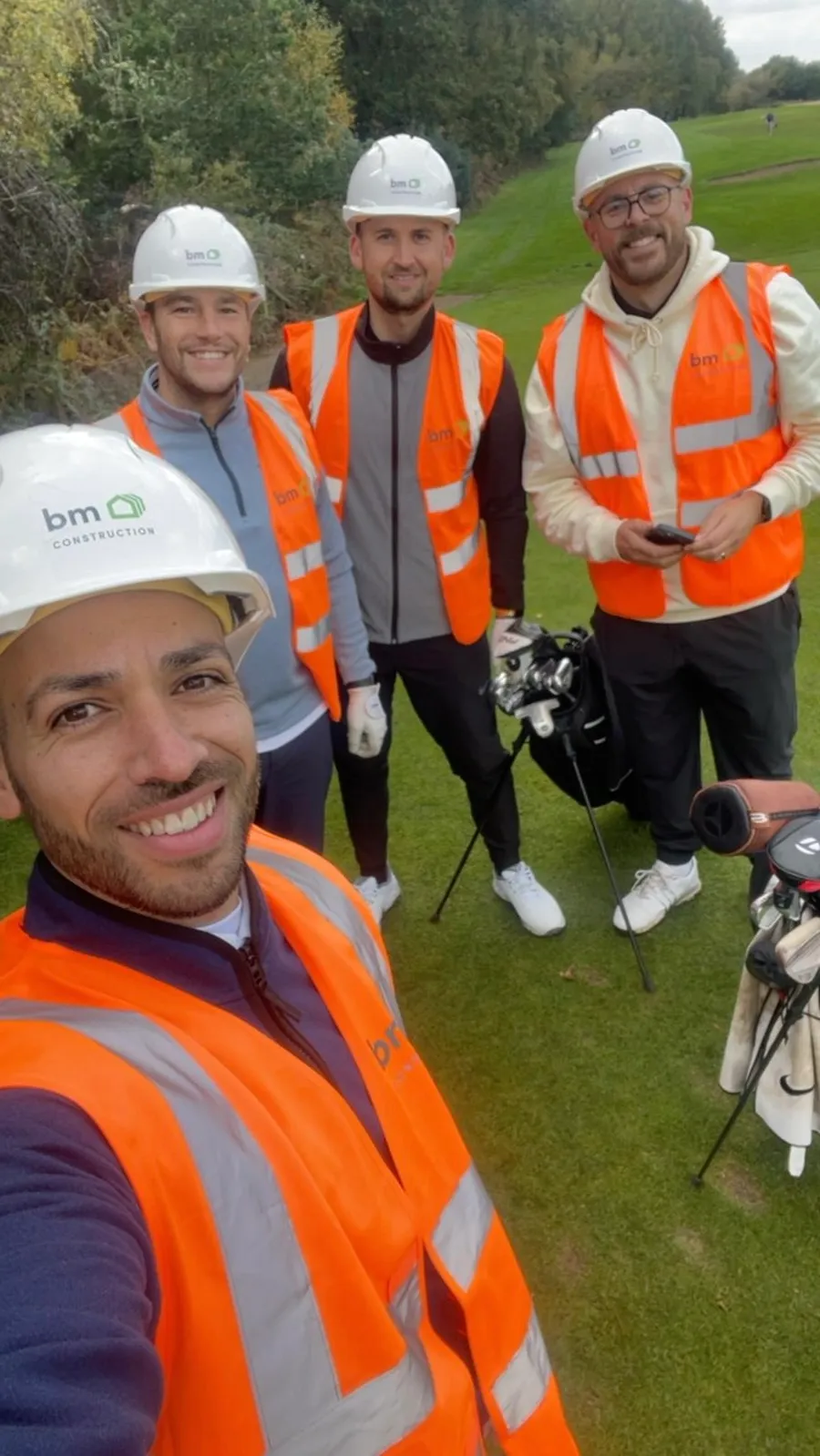 A group of construction workers posing for a picture.