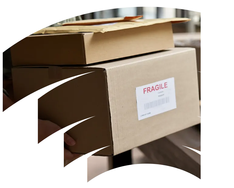 Boxes with fragile sticker on the front, being prepared for delivery