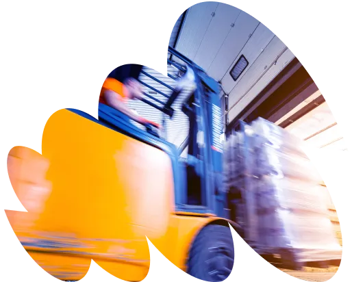 Blurred motion image of a yellow forklift loading a pallet of goods into a truck at a loading dock