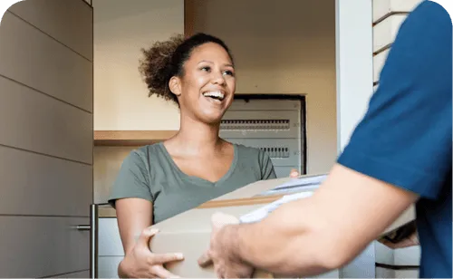 Smiling young child with curly hair, looking up at an adult in the foreground