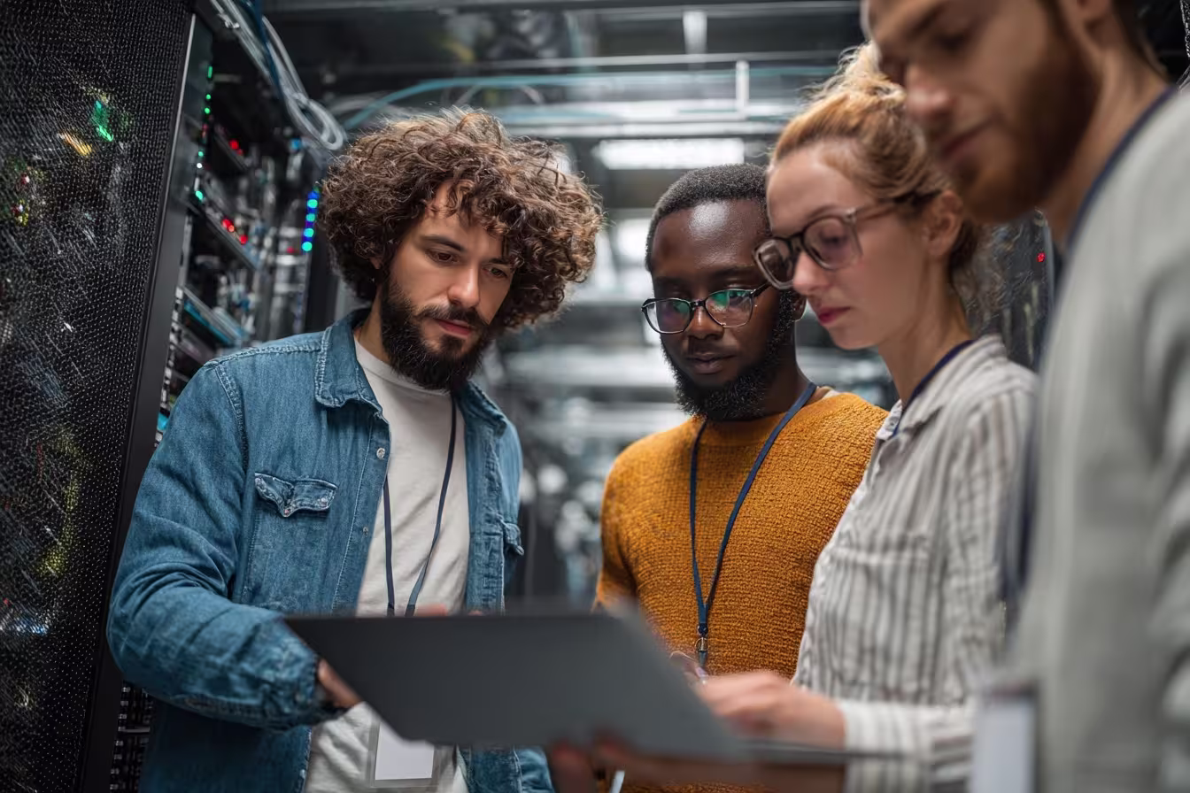 Diverse team reviewing network firewall configuration