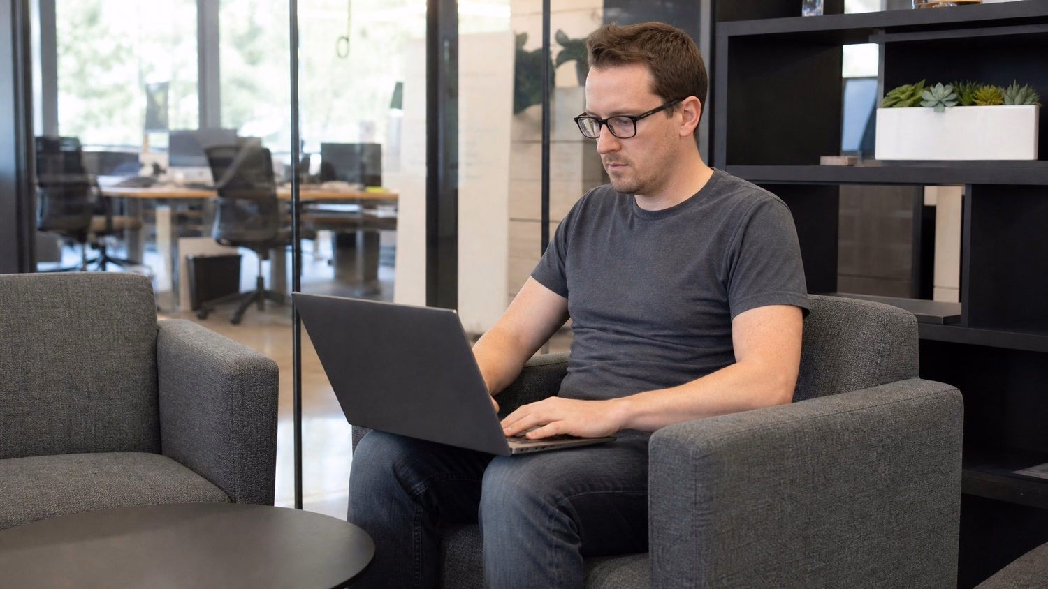 LOUNGE AREA LAPTOP An IT professional  one person working on a laptop in a ca