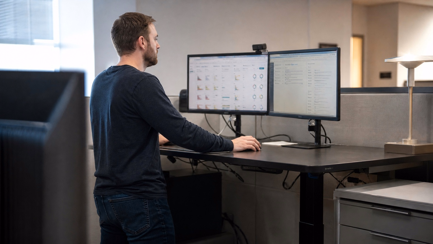 STANDING DESK An IT professional one person standing at a height-adjustable