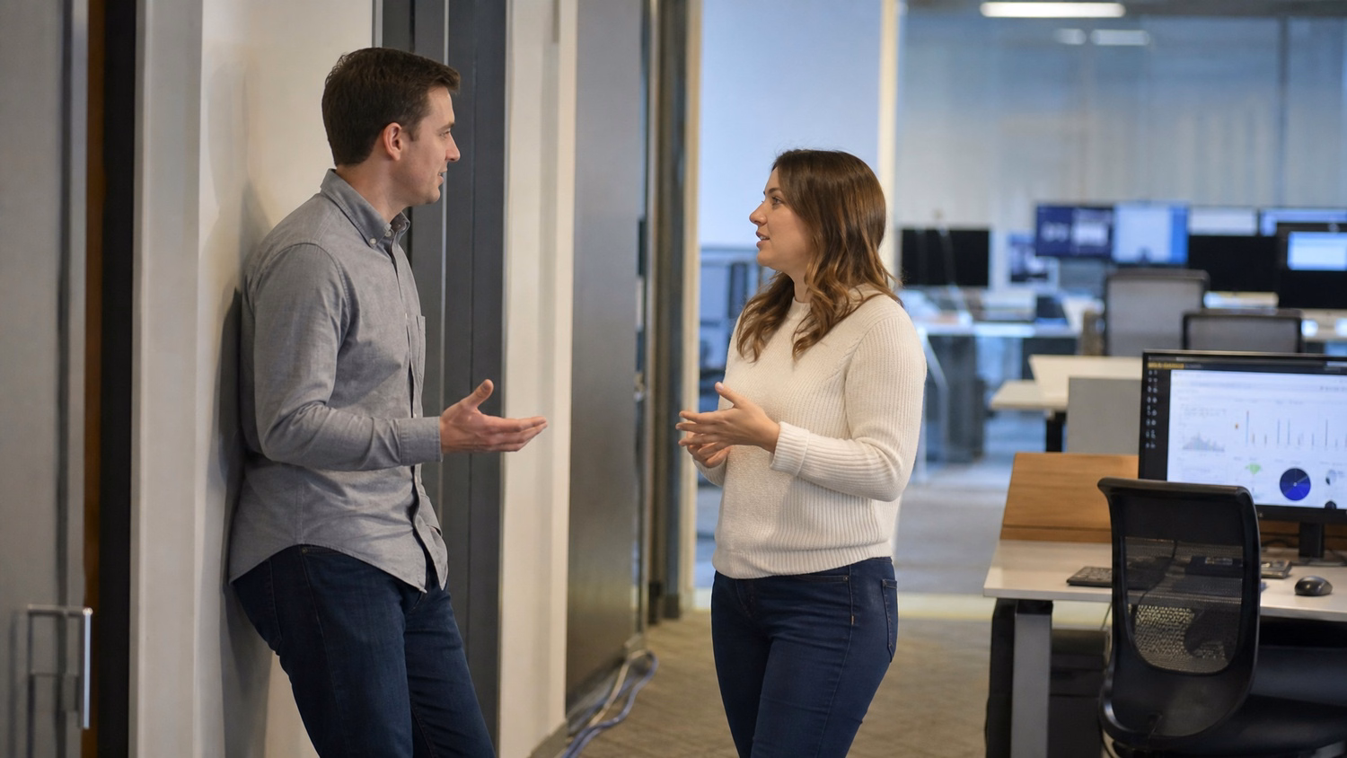 Colleagues discuss network cable near office hallway 60 chars
