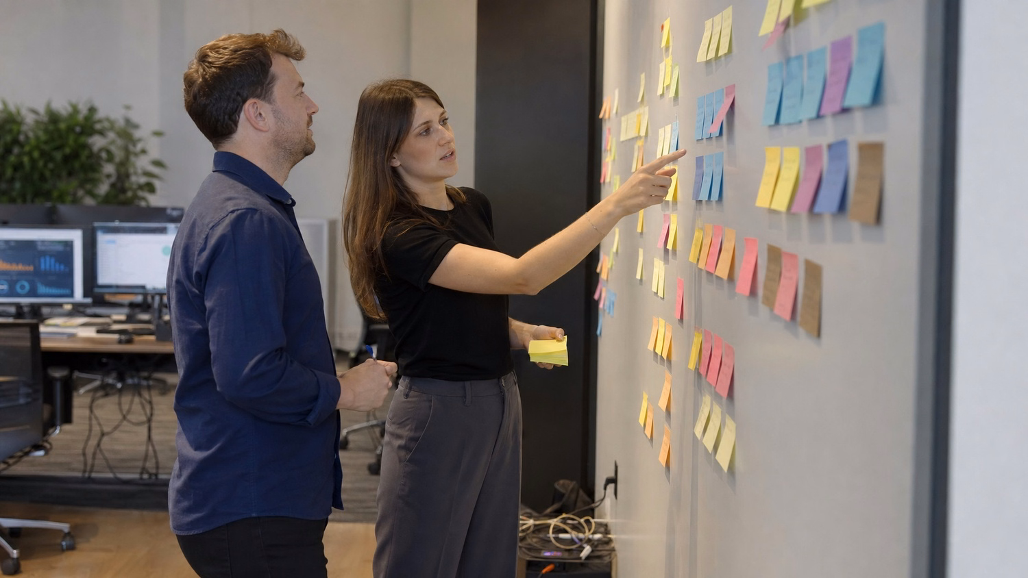 Team brainstorming cybersecurity ideas with sticky notes wall 55 chars