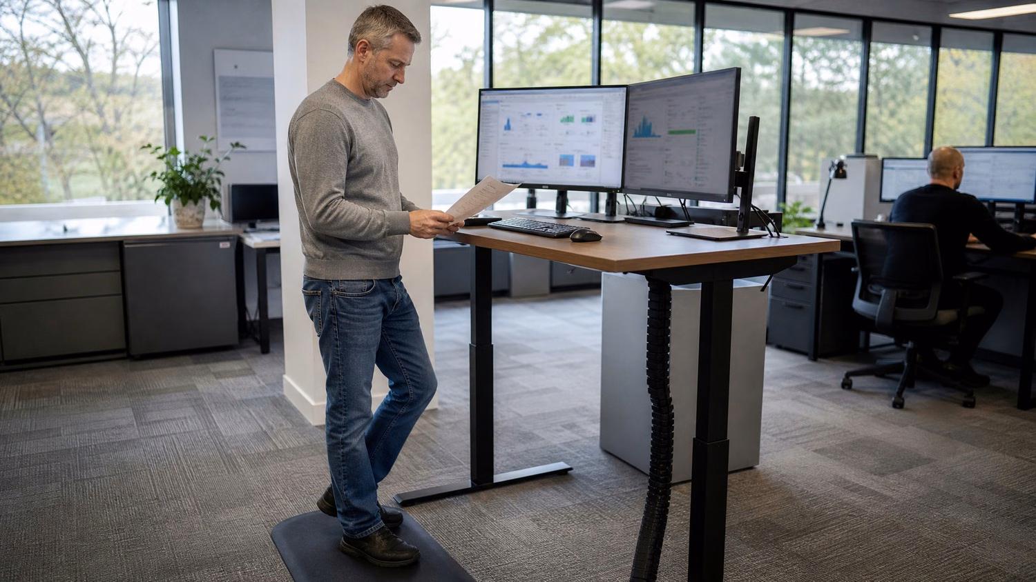 Man reviews automated backup report at standing desk 63 chars