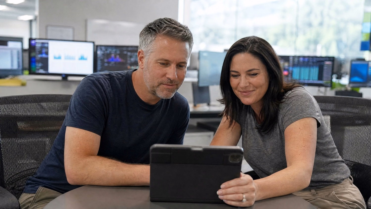 Security analysts review tablet data at a table