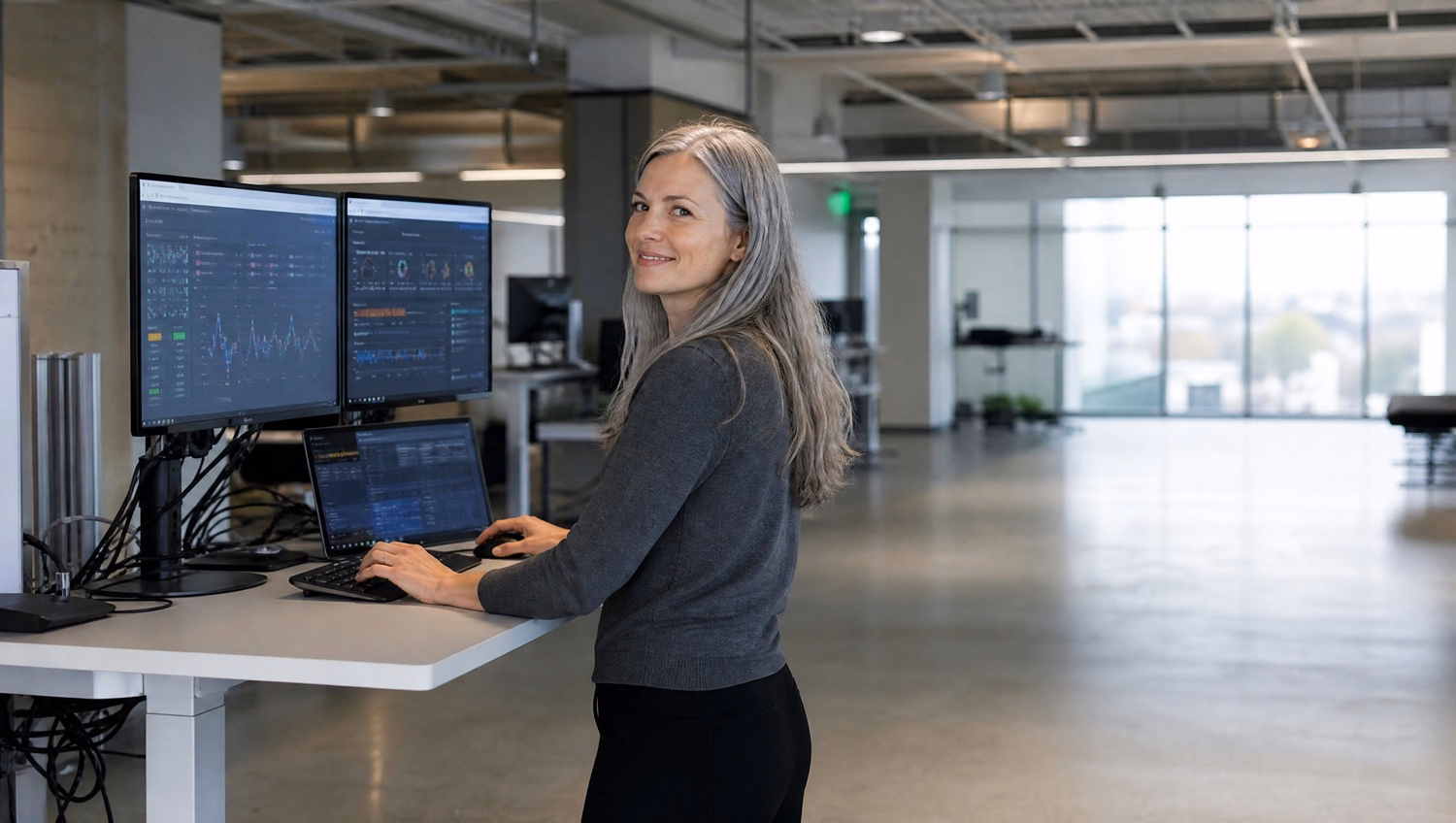Woman testing server script at standing desk in empty office 70