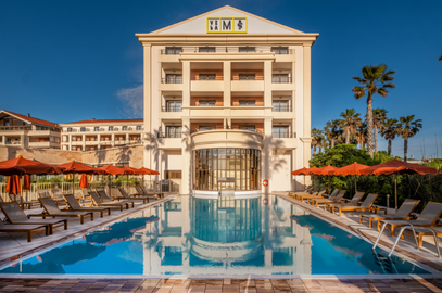 Luxury Villa M Marseille hotel with large outdoor pool, lounge chairs, and palm trees