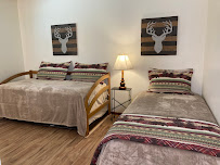 Cozy bedroom with two beds, striped bedding, and decorative wall art