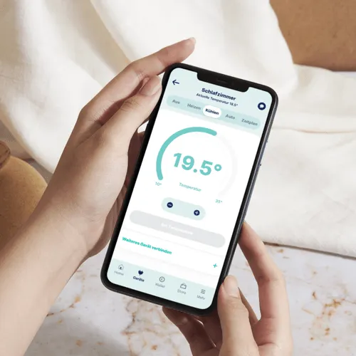 Hand holding phone showing Ostrom heating feature