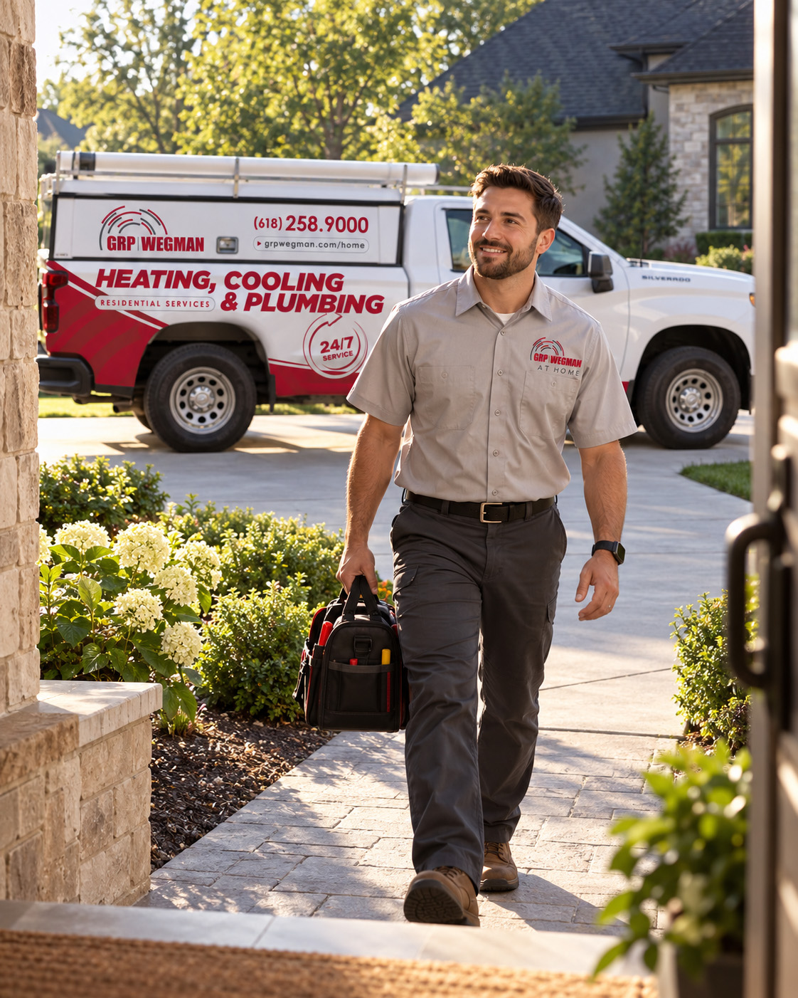 GRP|WEGMAN technician carrying a tool bag from his service truck to a customer’s home