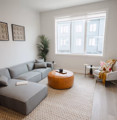 Cedarbrook Parkstone living room with sectional couch and large window looking outside