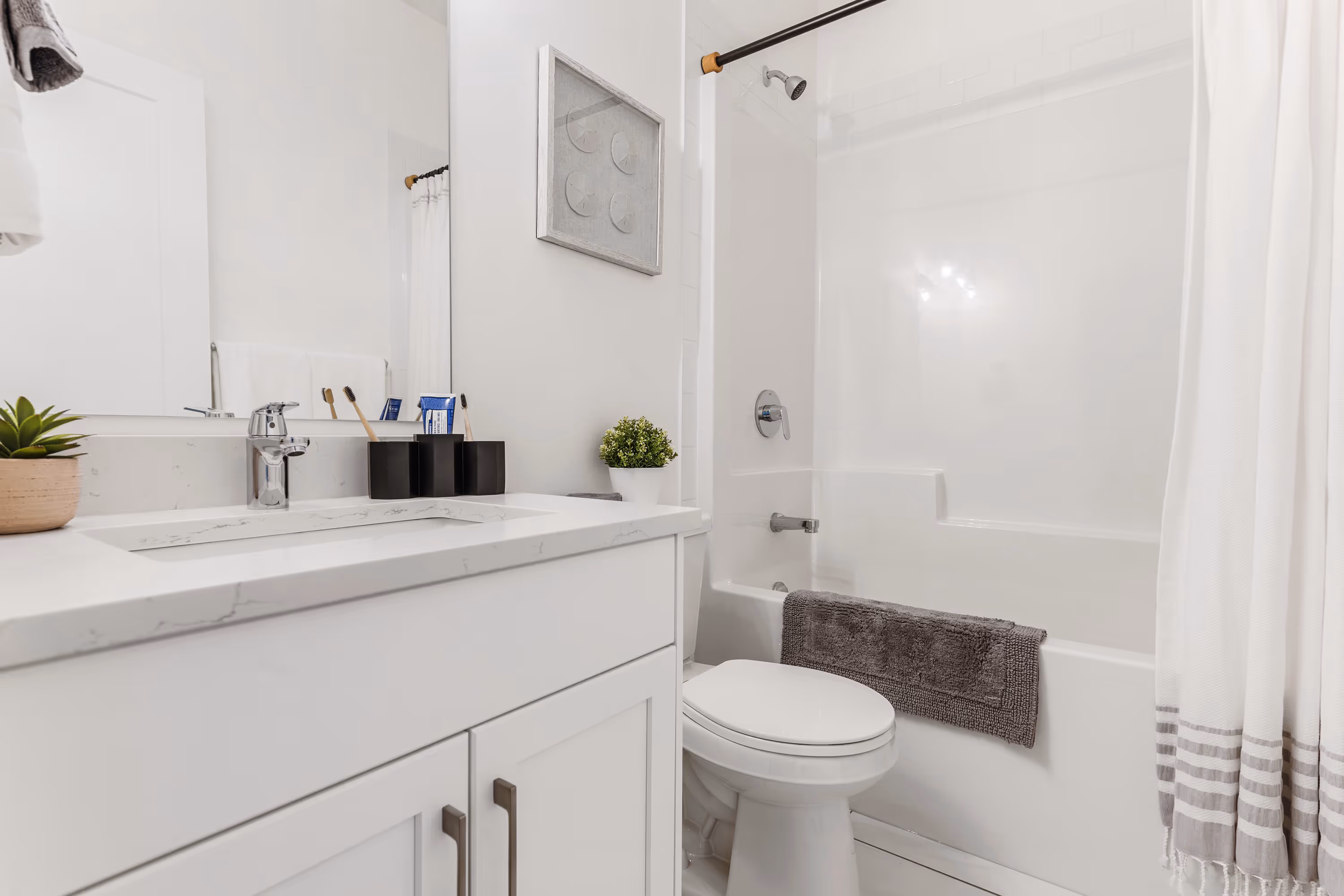 cedarbrook townhome bathroom with toilet, bath, shower, and sink countertop