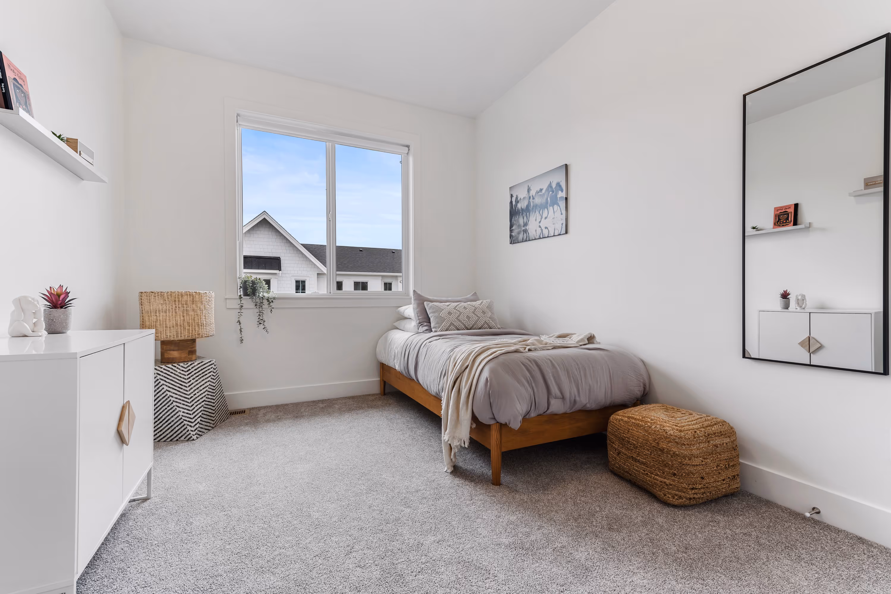cedarbrook townhome primary bedroom featuring queen bed and walk in closet with sliding barn doors 