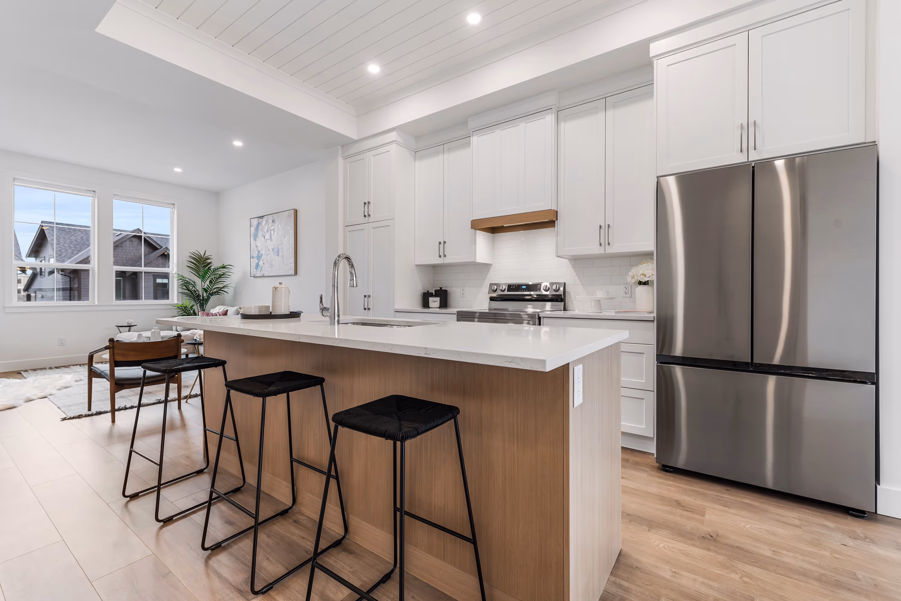 cedarbrook townhome kitchen with light wood island with granite top and stainless steel appliances