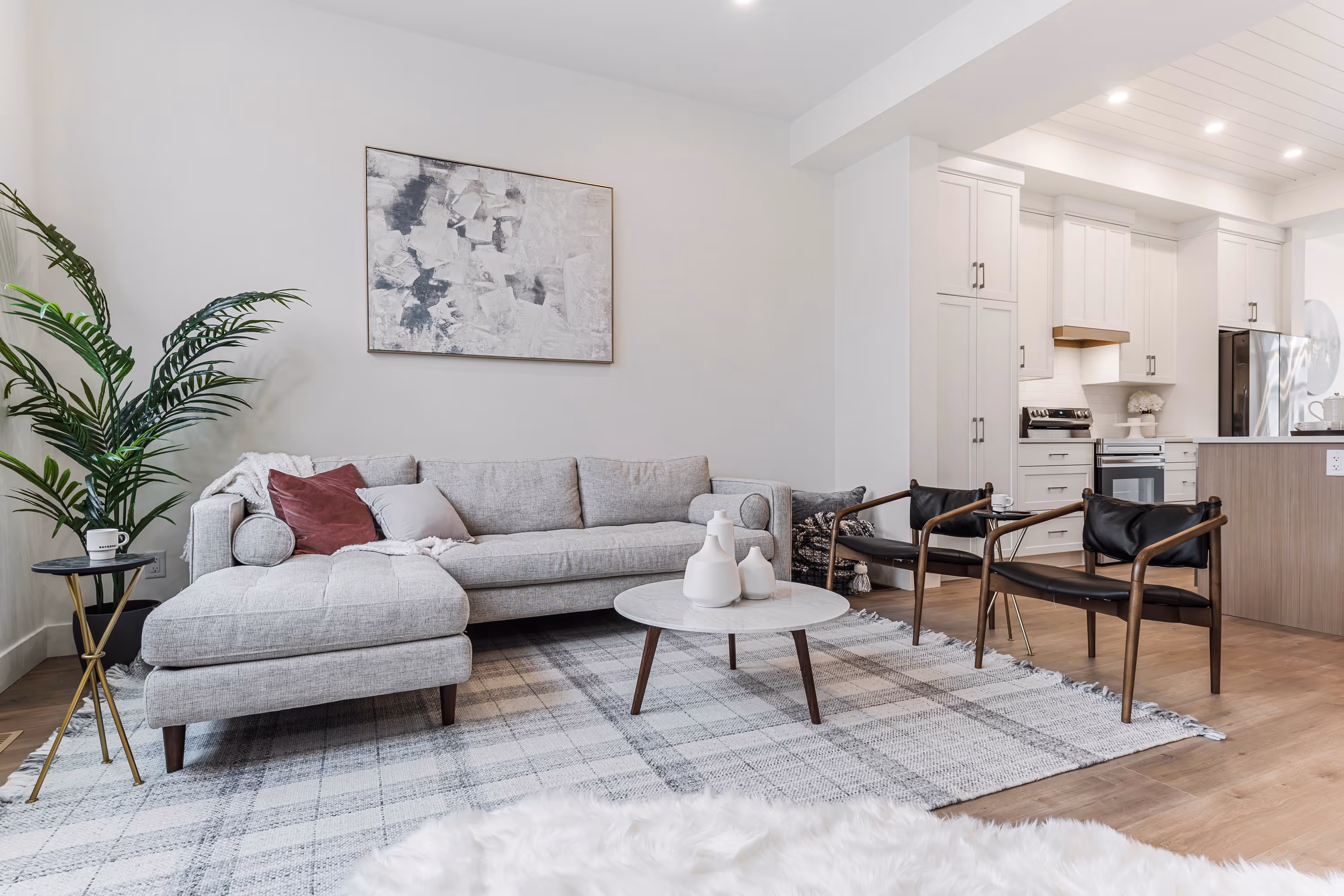 cedarbrook townhome living room with sectional couch, large plant and cozy rug