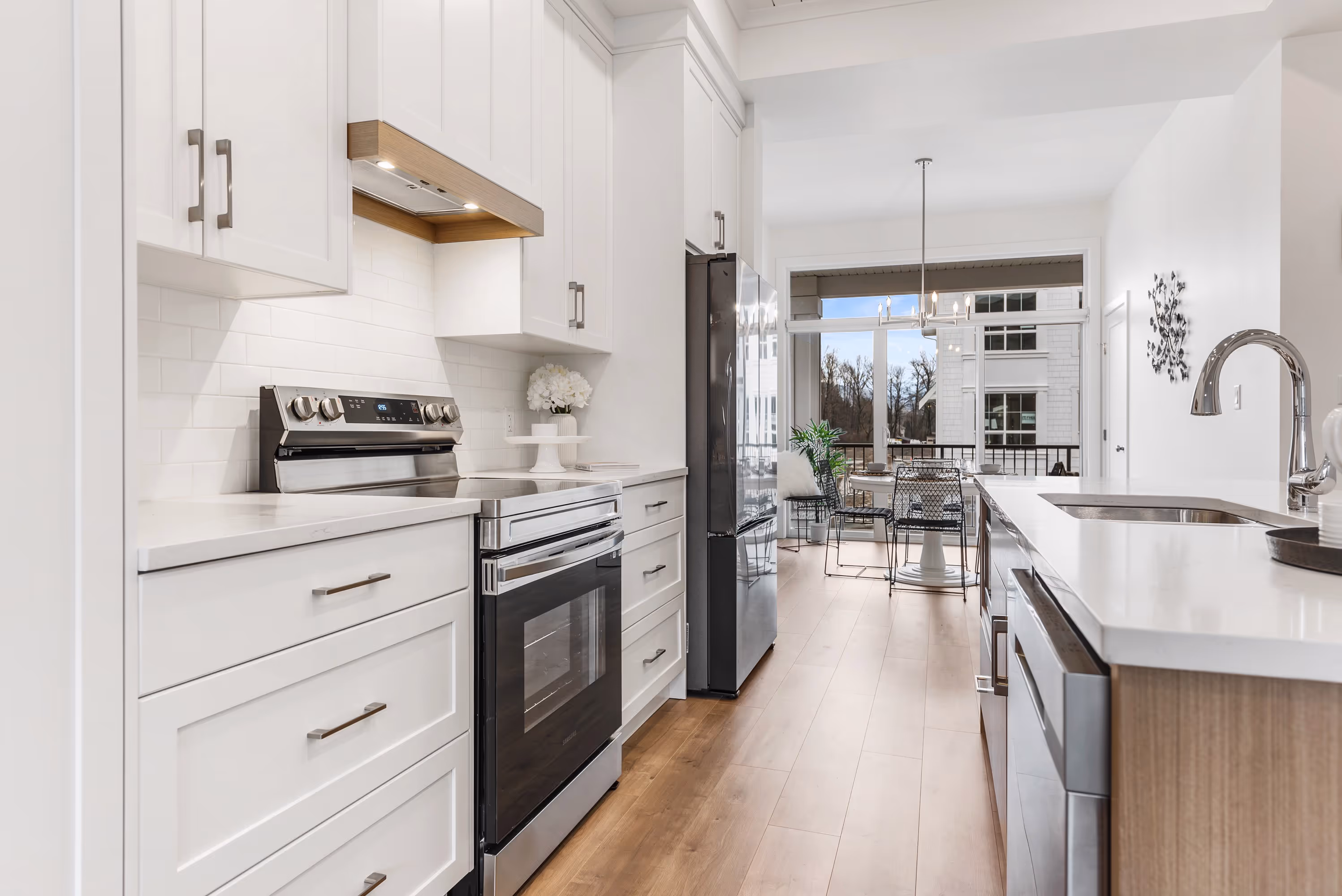 cedarbrook townhome bright kitchen with stainless steel appliances, light wood accents and light cabinets