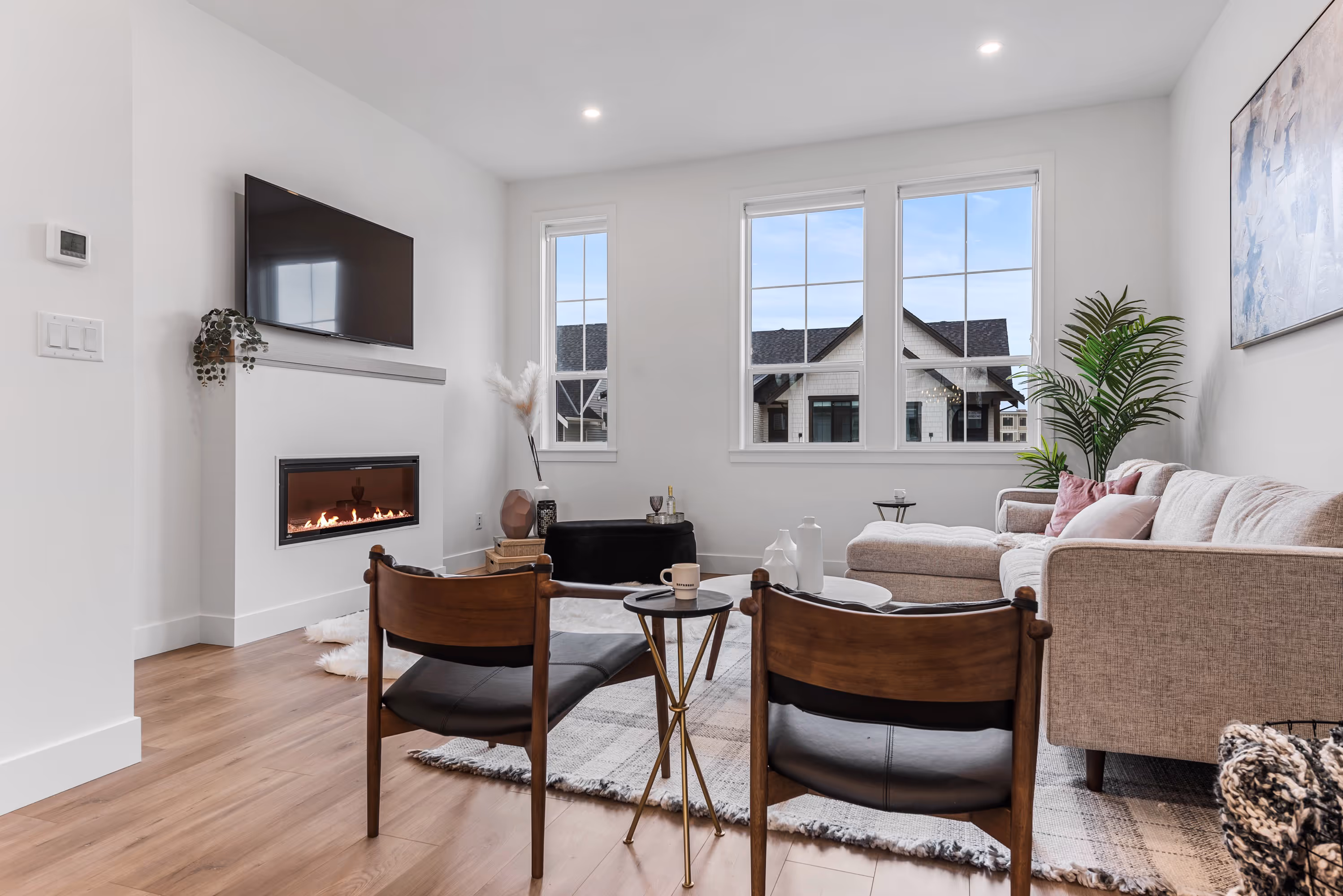 cedarbrook townhome living room featuring a fireplace and mantel with large windows 
