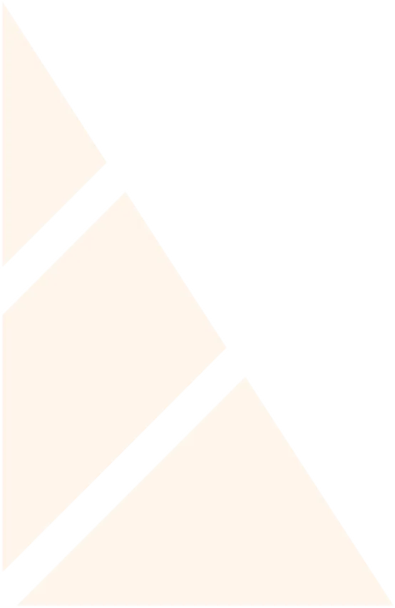 Smiling young man with a beard, short curly hair, and a white jacket against a dark background.