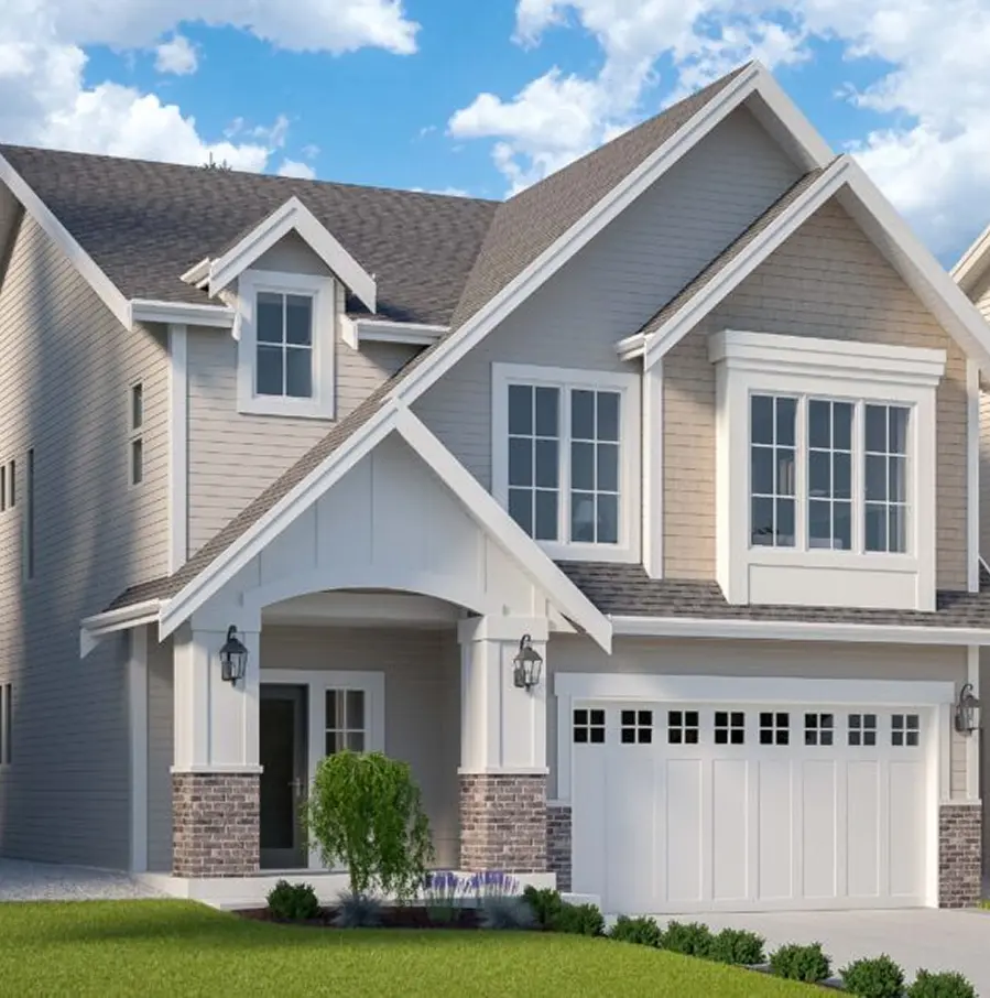Aerial view of a residential neighborhood with rows of modern houses surrounded by dense green trees.