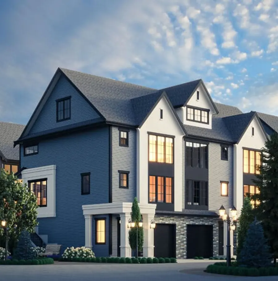 Aerial view of a residential neighborhood with rows of modern houses surrounded by dense green trees.