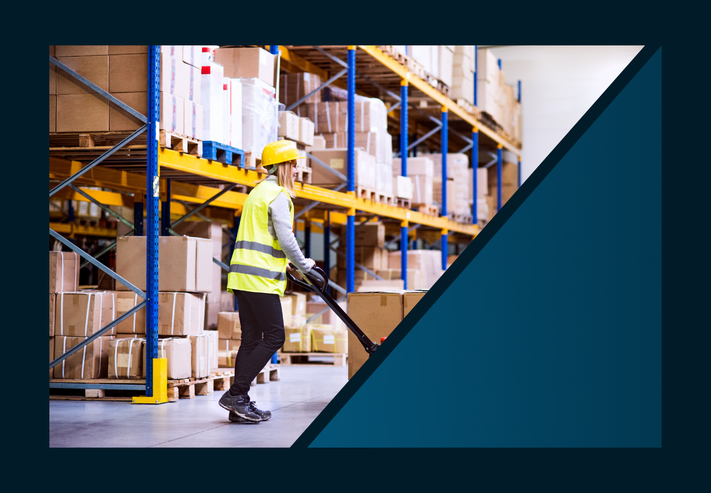 Warehouse worker in yellow using a pallet jack next to warehouse shelving