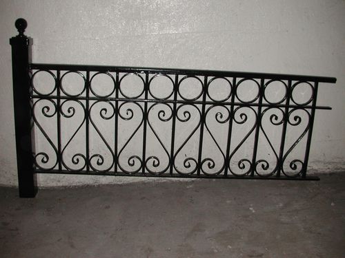 Iron wrought security fence with S shaped design.