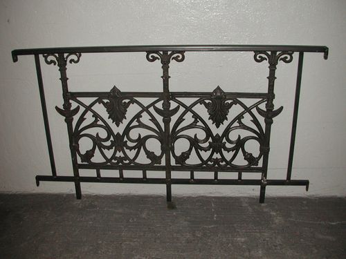 Iron wrought security railing with intricate design.