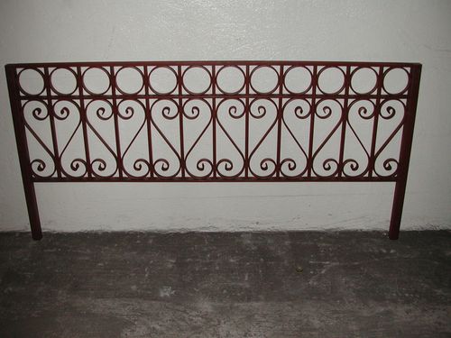 Iron security fence with S shaped and circular designs.