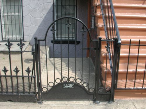 Iron security gate in front of basement entrance.