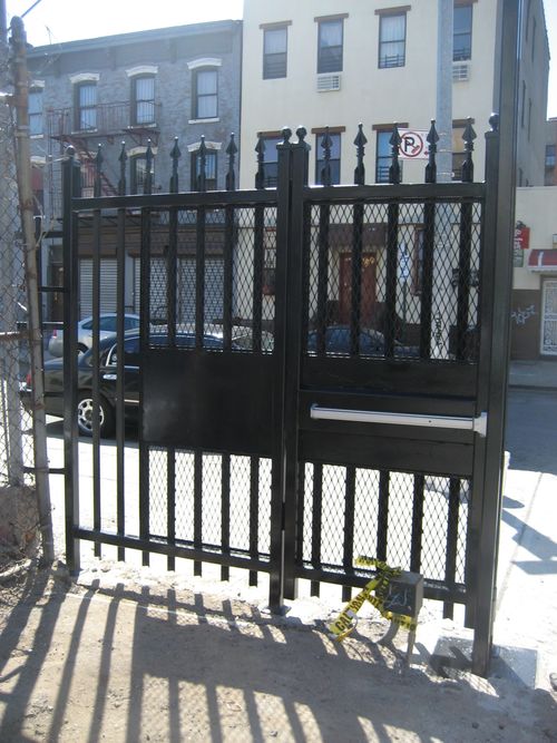 Street-level security entrance metal doors with interior push bar.