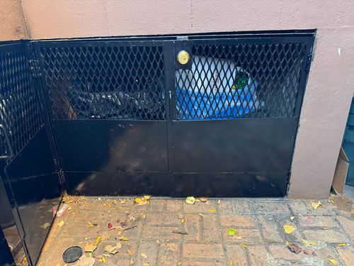 Garbage enclosure half expanded metal, half metal panel