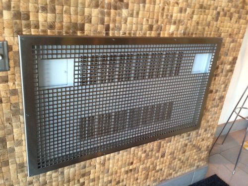 Rectangular perforated metal ventilation grille with a square grid pattern, mounted in a brushed stainless steel frame