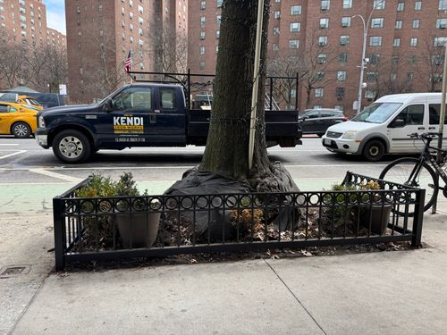 TG040 NYC Parks Recommended Style B, features solid steel corner posts with clean mitered joints, a molded top rail with circular cutouts, and a curved front edge