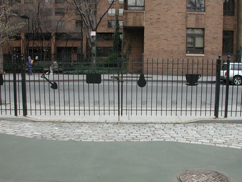 R187 Fence with evenly spaced vertical pickets topped with ball finials, a flat top rail with an intermediate stabilizing rail, decorative spiral scrolls near the base, and playful silhouette cutouts