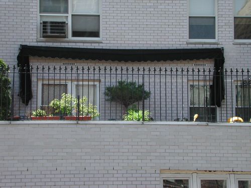 R188 Fence with tightly spaced vertical pickets with alternating single and double spear-point finials