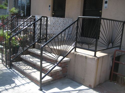 R194 Sunshine design with radial steel pickets emanating from semi-circular bases, framed within rectangular welded panels and secured with surface-mounted posts