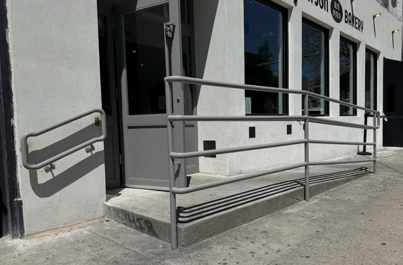 R203 ADA-compliant steel ramp guardrail and handrail system fabricated from schedule pipe railings with welded horizontal returns and vertical support posts