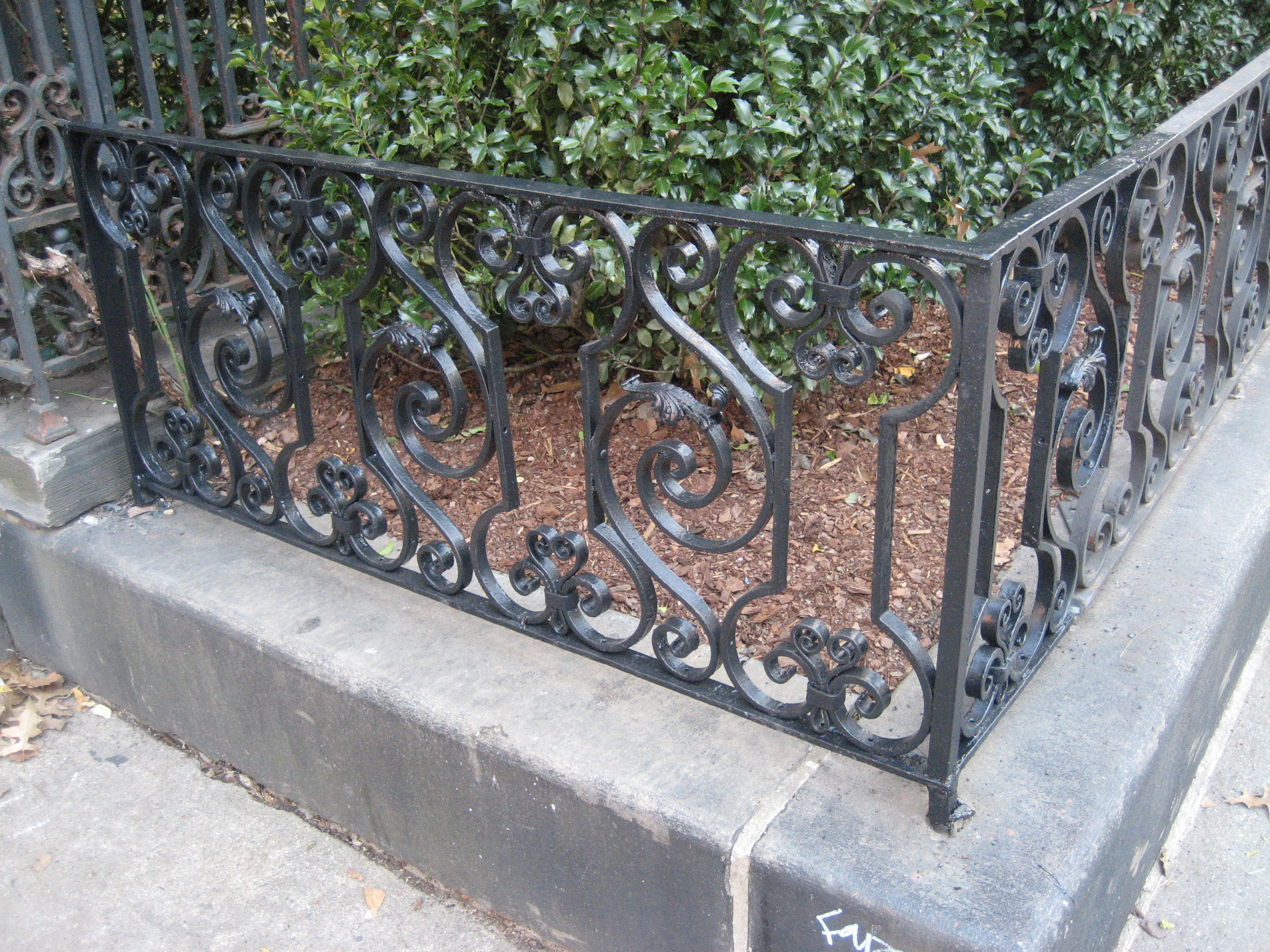 R209 Traditional wrought iron garden fence featuring ornate scrollwork panels with repeating C-scrolls, S-scrolls, and rosette-style floral clusters