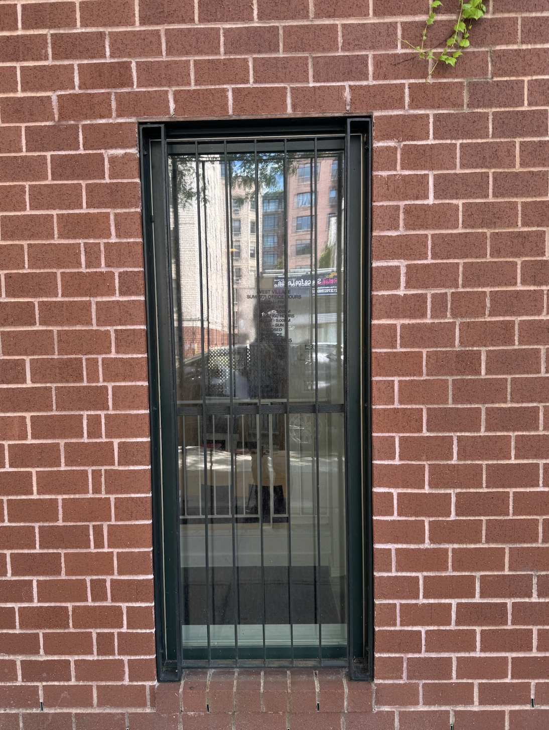 GU153 Minimalist steel window security grille features closely spaced vertical bars welded into slim side channels