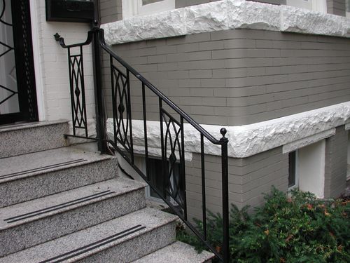 R214 Iron railing features vertical pickets with intersecting diagonal bars forming a diamond lattice pattern accented by a central lozenge detail in each panel.