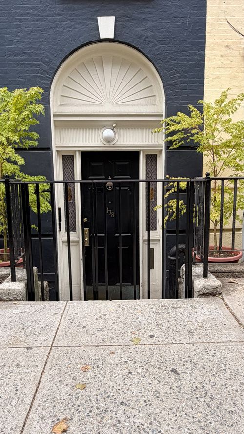 R222 Steel railing and gate with evenly spaced vertical pickets, square posts, and understated ball finials
