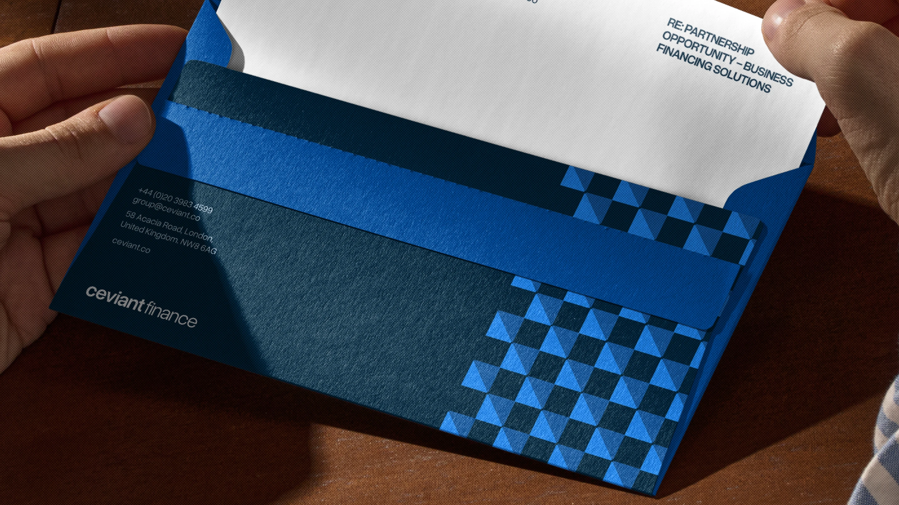 A person holding a business card in their hand.