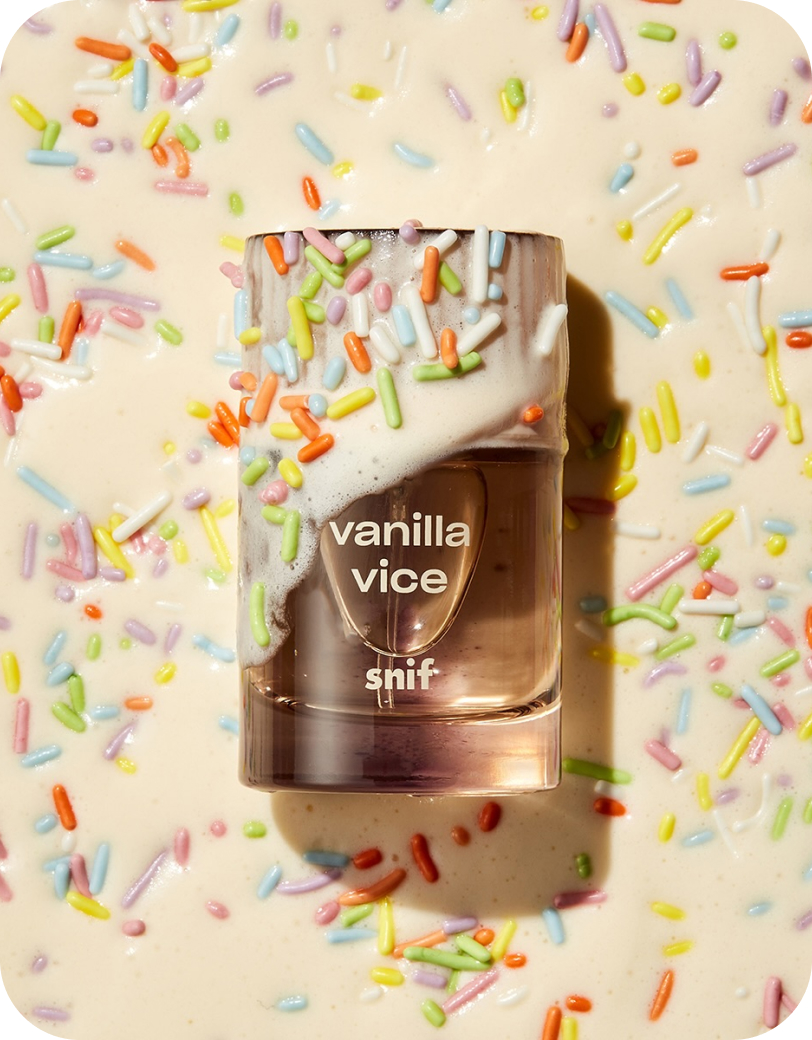 Bottle of Snif Vanilla Vice fragrance surrounded by colorful candy sprinkles.