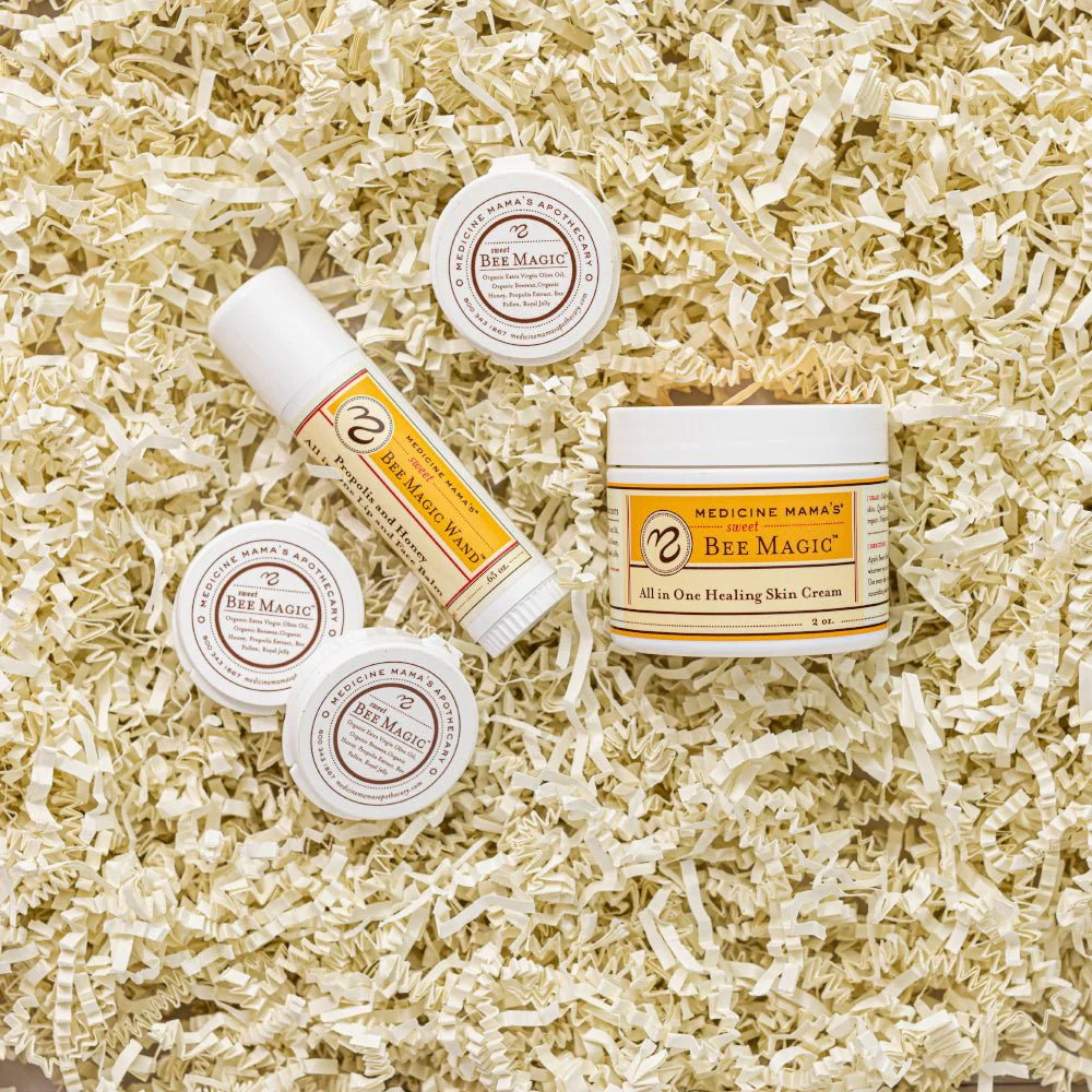 Sweet Bee Magic gift set of Medicine Mama's healing skin cream and balms nestled in paper shreds.
