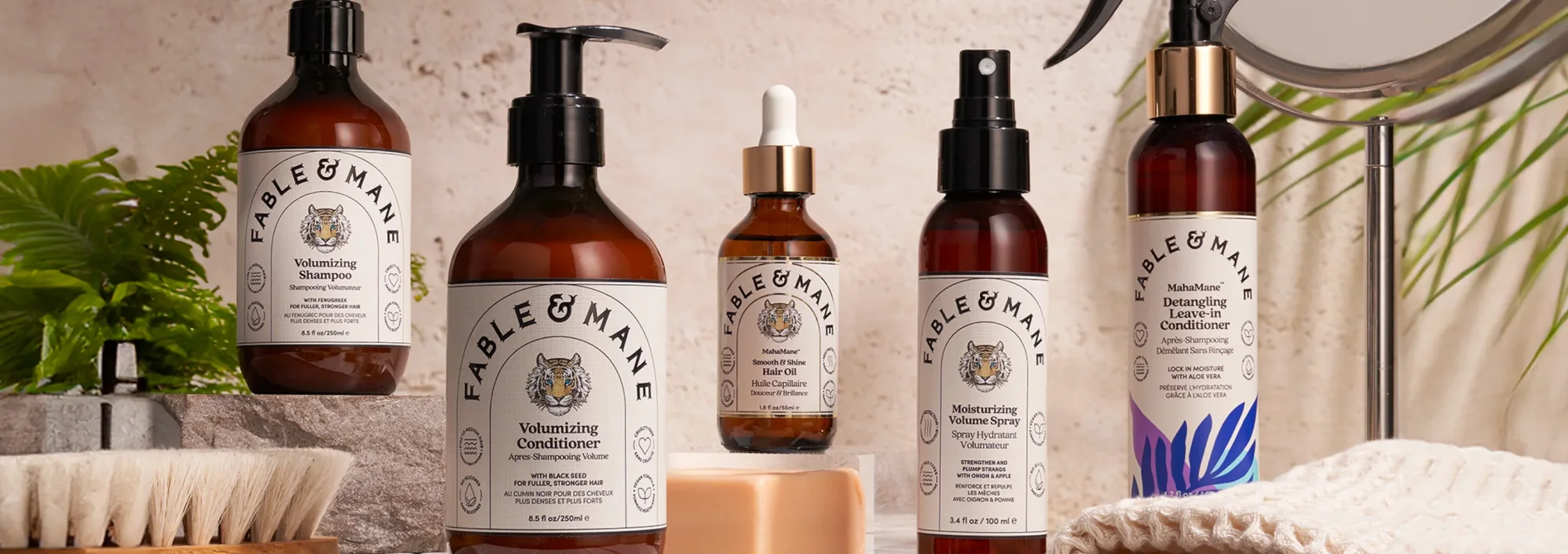 Fable and Mane hair care lineup with shampoo, conditioner, hair oil, and volume spray on a bathroom counter.