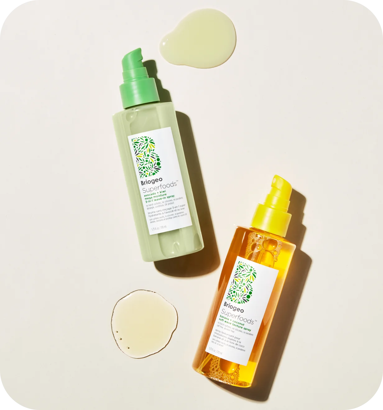 Briogeo product photo of two Superfoods hair care spray bottles with product swatches.